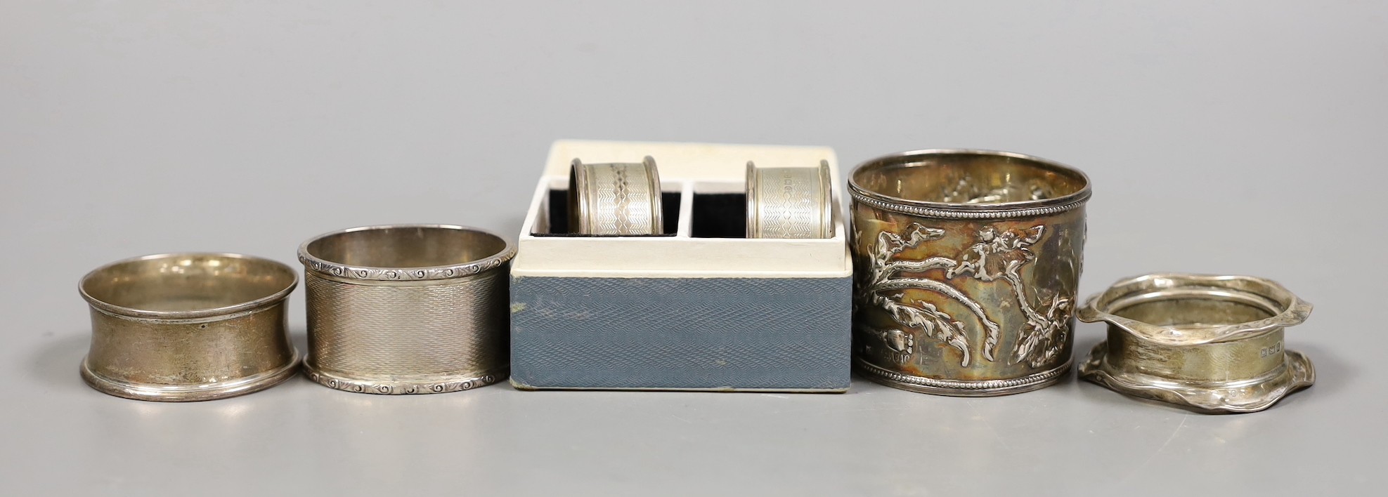 Six assorted silver napkin rings including a pair, Birmingham, 1913.